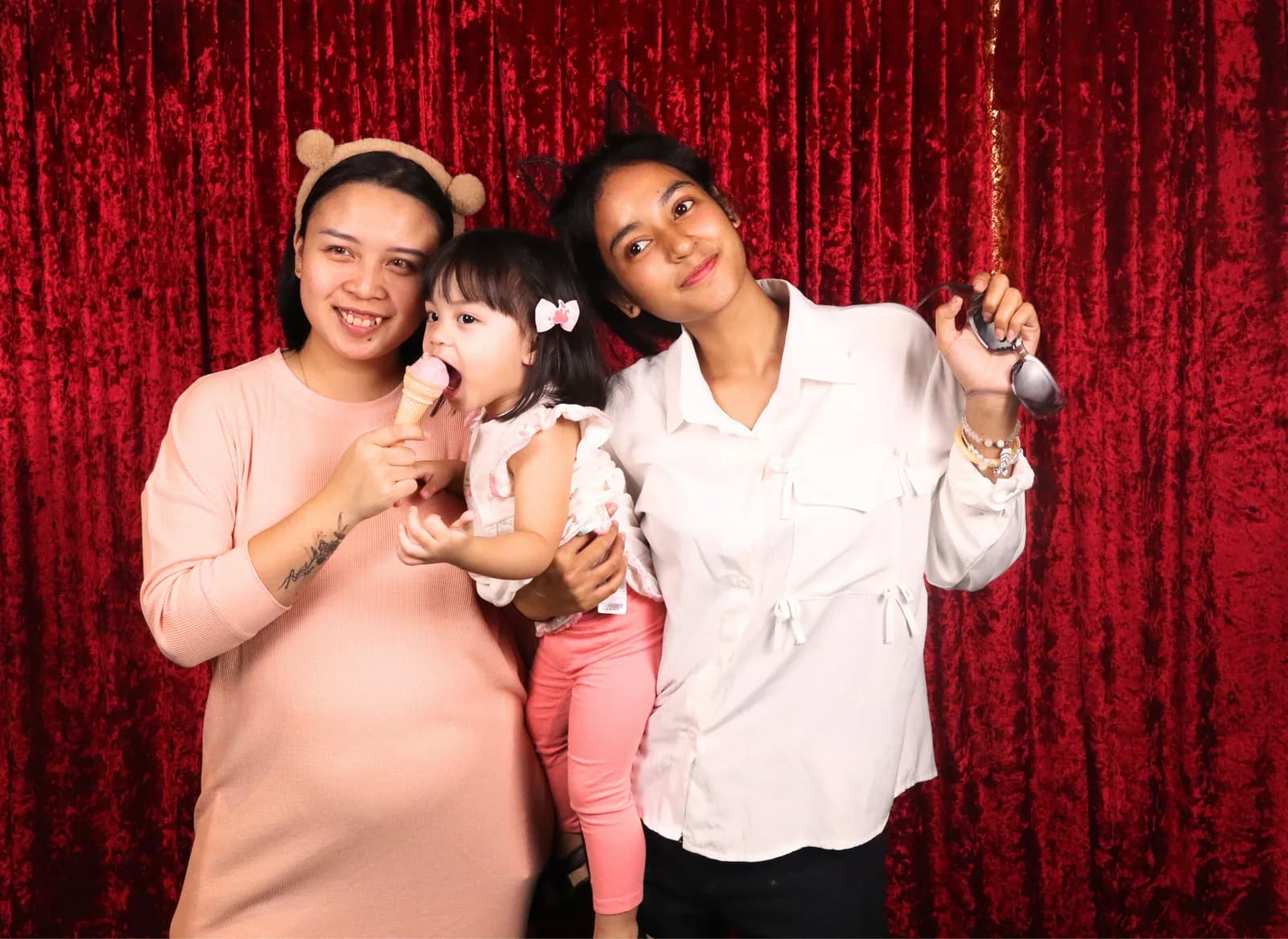 A child and family posing with ice cream props at a birthday party