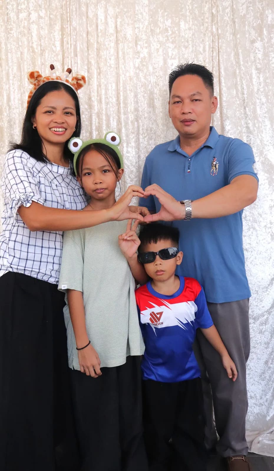 A family making a heart pose together at the photo booth