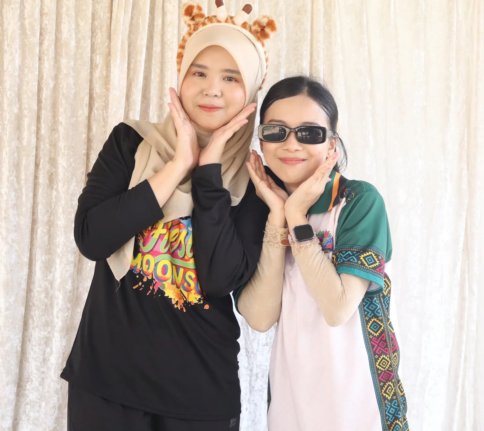 Two friends posing with sunglasses and a giraffe headband